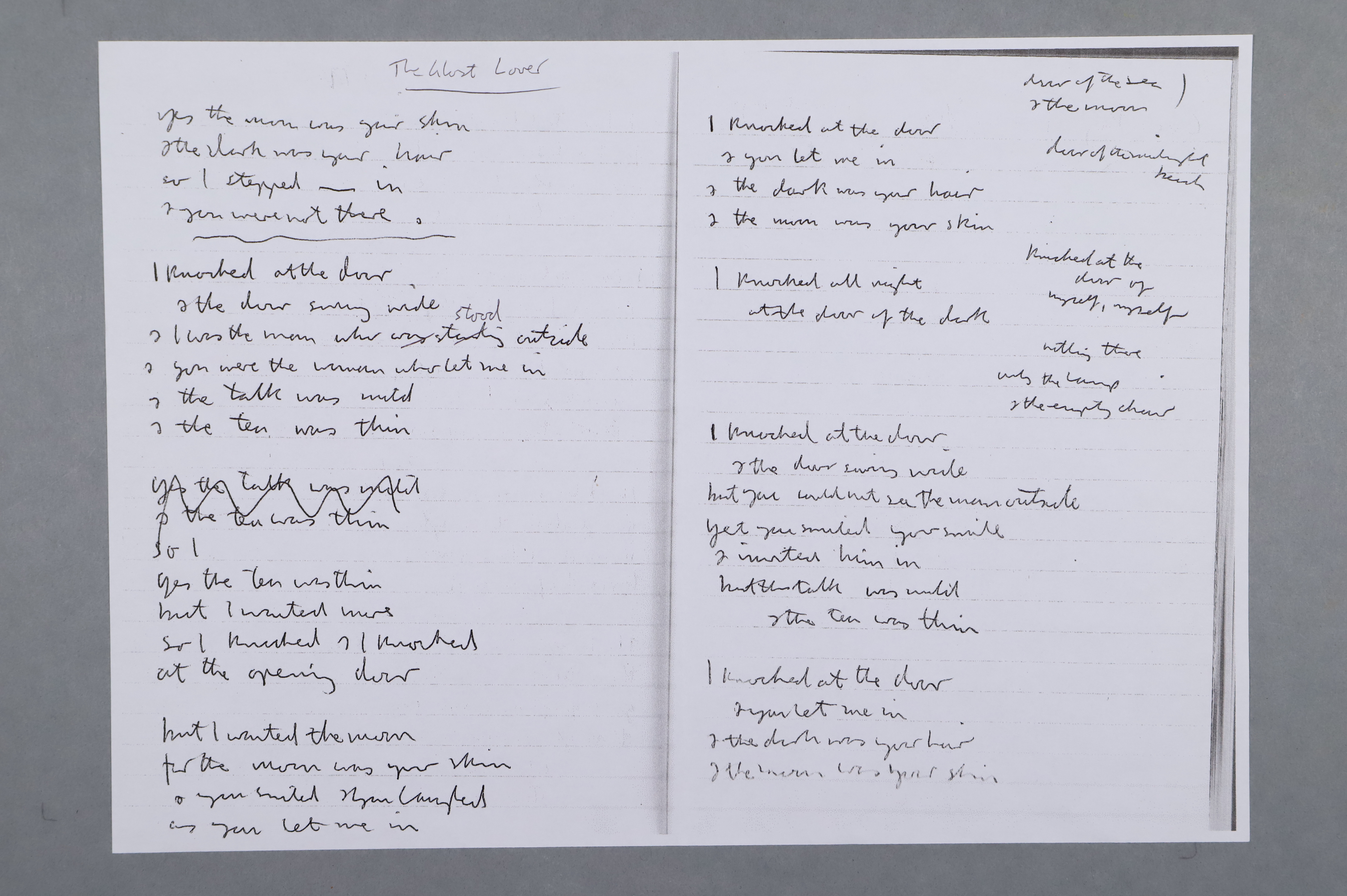A photocopy of a manuscript poem draft in a notebook.